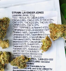 detail of lavender jones terpene testing label with buds scattered around