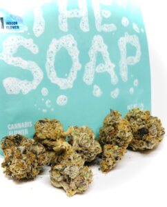 buds of the soap in front of cookies culta turquoise ziplock container with the soap written in bath bubble text graphic
