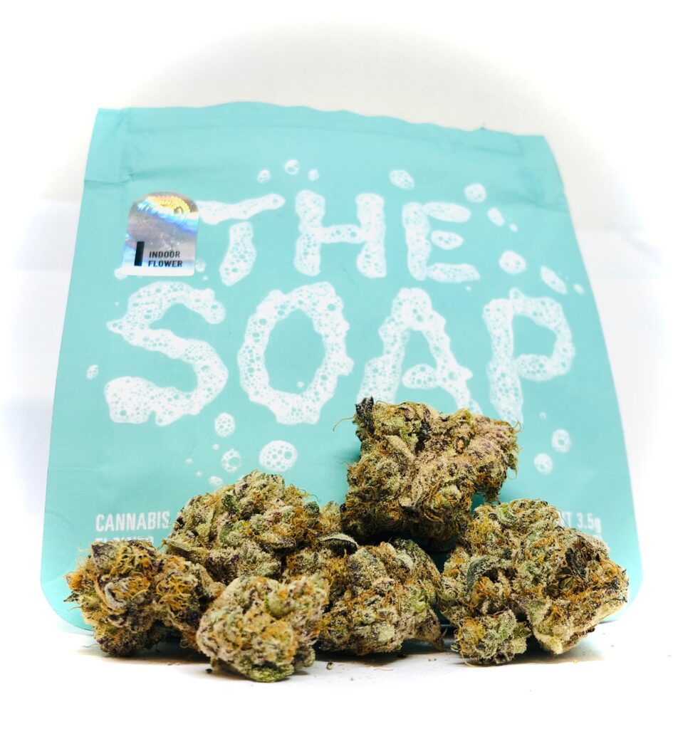 main photo of the soap by cookies and culta displaying buds in front of turquoise culta ziplock