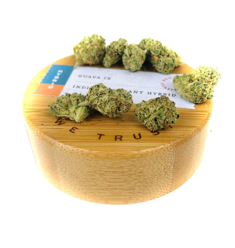 wooden lid of natures heritage 7 gram jar with buds of guava ix strain on top